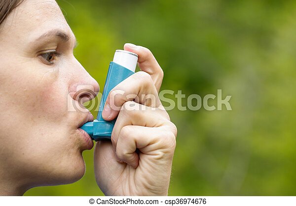 Asthma patient inhaling medication for treating shortness of breath and ...